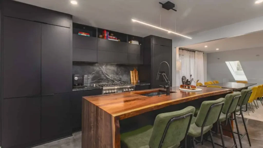 kitchen-remodeled-with-black-cabinets-and-wooden-countertops